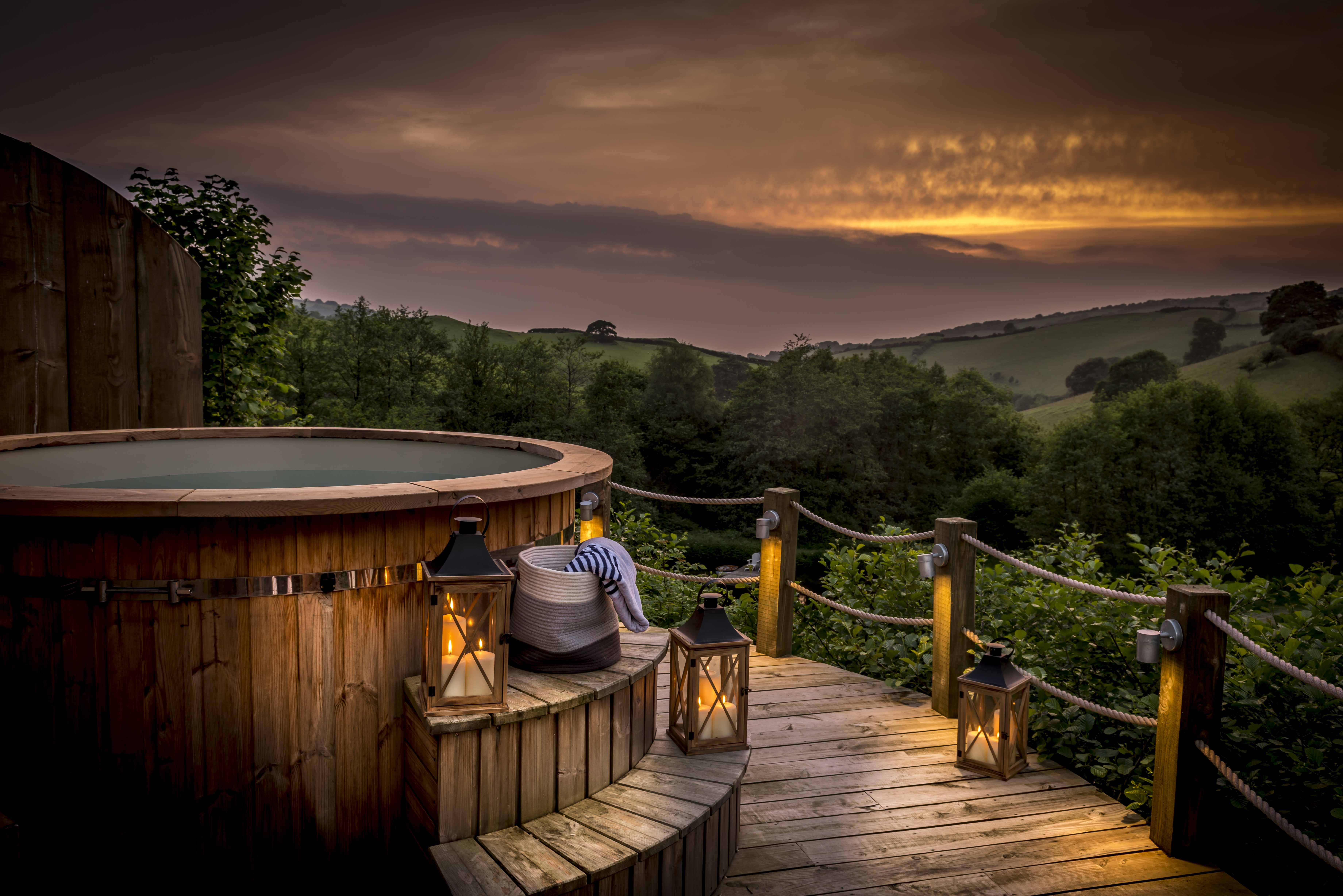 Watch the setting sun from the Longlands hot tub. Luxury glamping amongst gorgeous south west countryside.